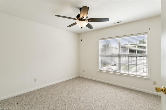 carpeted empty room featuring ceiling fan