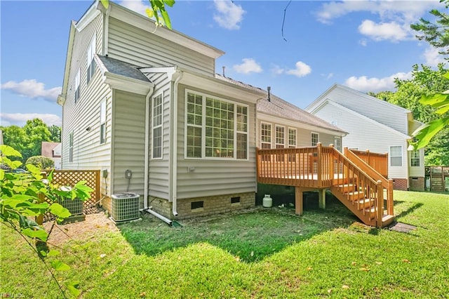 rear view of house with a yard, a deck, and cooling unit