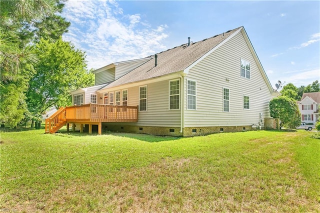 rear view of house with a yard and a wooden deck