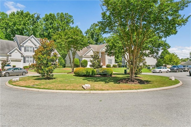 view of property hidden behind natural elements featuring a front lawn