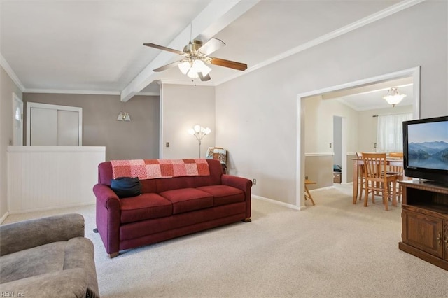 carpeted living room featuring ceiling fan, lofted ceiling with beams, and ornamental molding