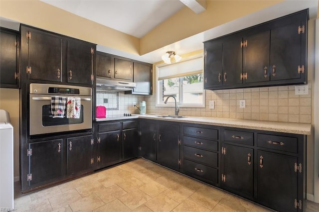 kitchen with backsplash, stainless steel oven, cooktop, and sink