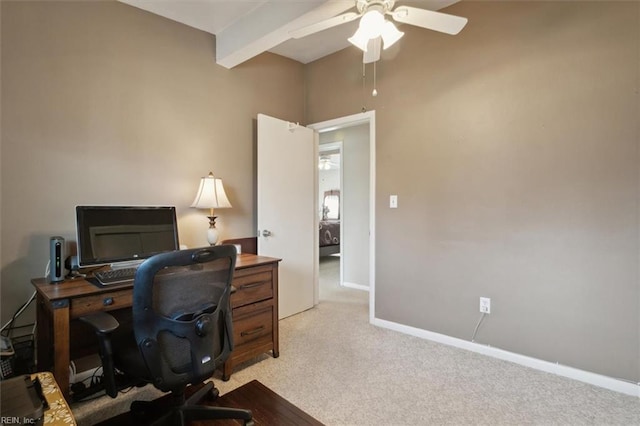 carpeted home office featuring ceiling fan and beamed ceiling