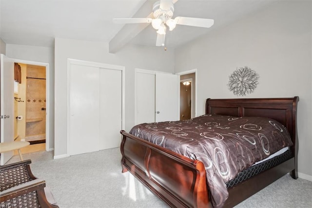 carpeted bedroom with beamed ceiling, ceiling fan, and connected bathroom