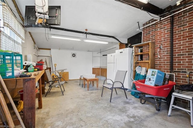 garage featuring a workshop area and white fridge