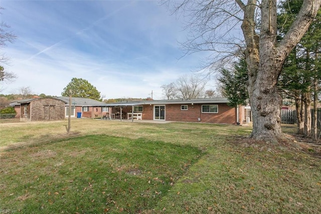 rear view of property with a yard and a patio