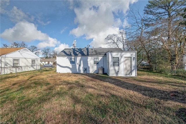 rear view of property featuring a lawn