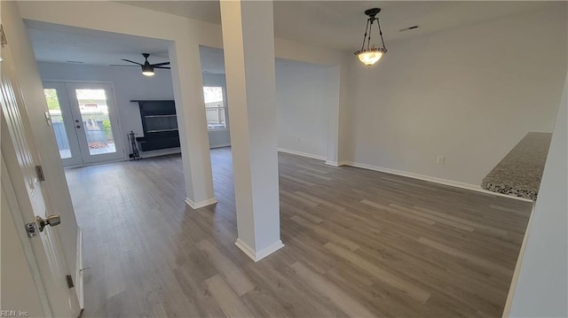 interior space with hardwood / wood-style floors, french doors, and ceiling fan