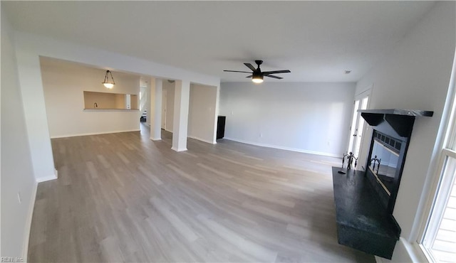 unfurnished living room with ceiling fan and hardwood / wood-style flooring