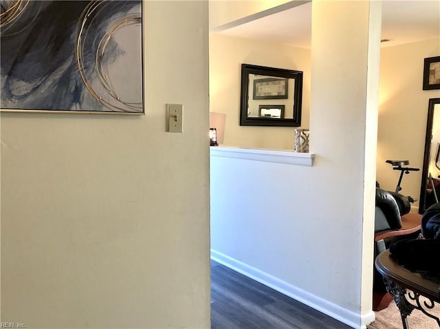 hallway with dark hardwood / wood-style flooring