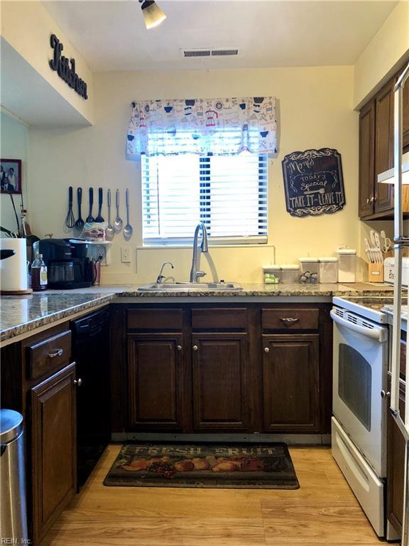 kitchen featuring dark brown cabinetry, sink, light hardwood / wood-style flooring, dishwasher, and white electric range