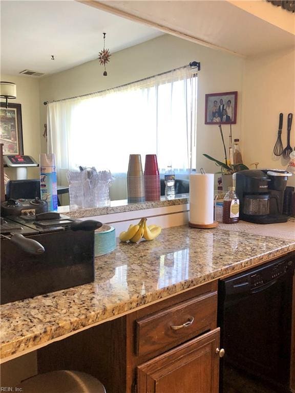 kitchen with dishwasher and light stone countertops