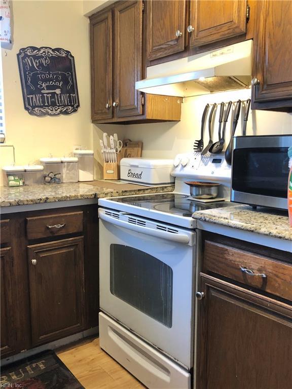 kitchen with white electric range oven and light hardwood / wood-style floors