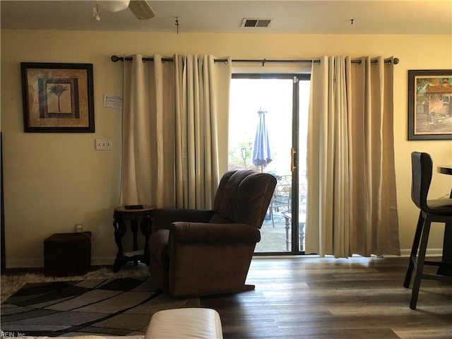 living area featuring hardwood / wood-style flooring and ceiling fan