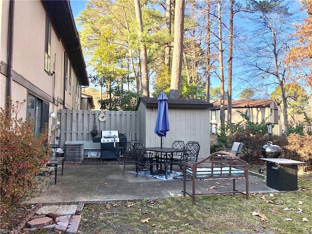 view of patio with central AC unit and a grill