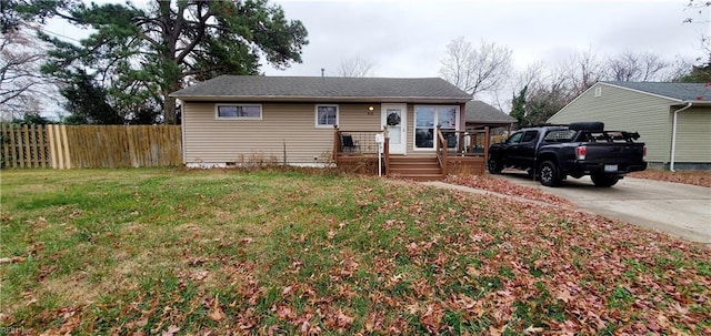 view of front of house with a wooden deck and a front yard