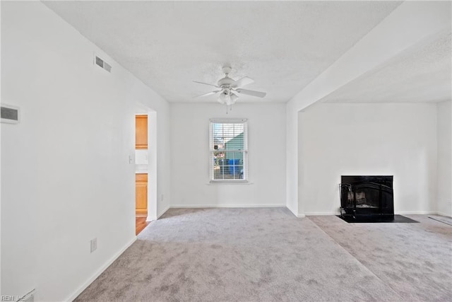 unfurnished living room featuring light carpet and ceiling fan