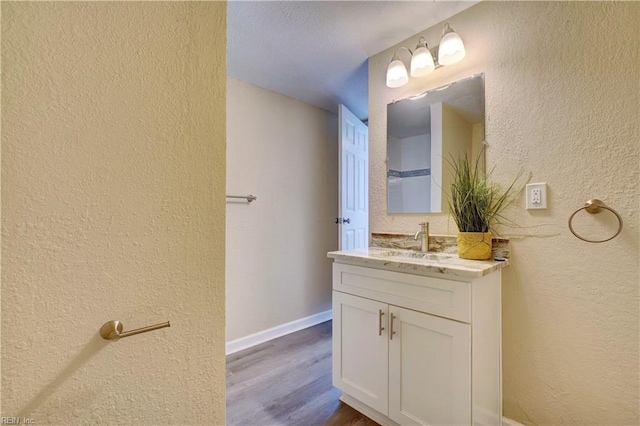 bathroom with vanity and hardwood / wood-style flooring