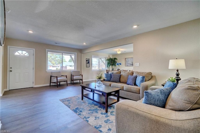 living room with dark hardwood / wood-style floors and a textured ceiling