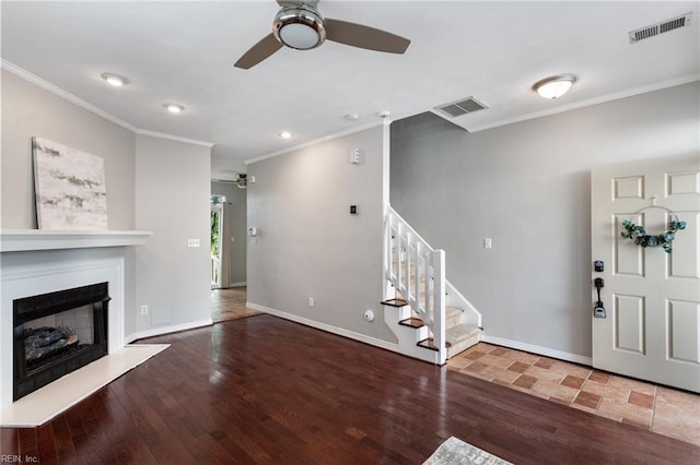 interior space featuring ceiling fan, dark hardwood / wood-style flooring, and ornamental molding