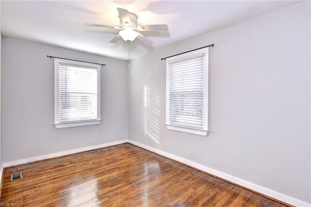 spare room with hardwood / wood-style flooring and ceiling fan