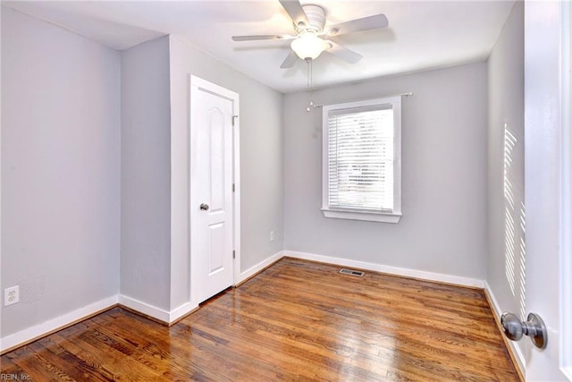 spare room with hardwood / wood-style flooring and ceiling fan