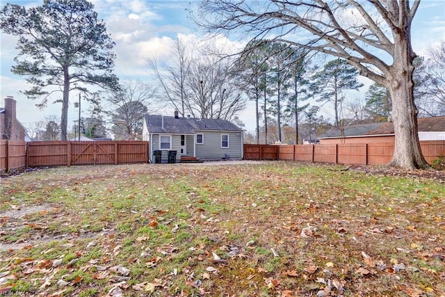 rear view of house featuring a lawn