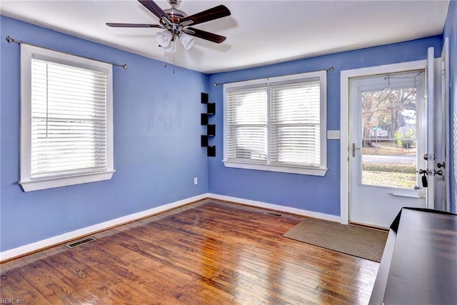 interior space featuring ceiling fan and dark hardwood / wood-style floors