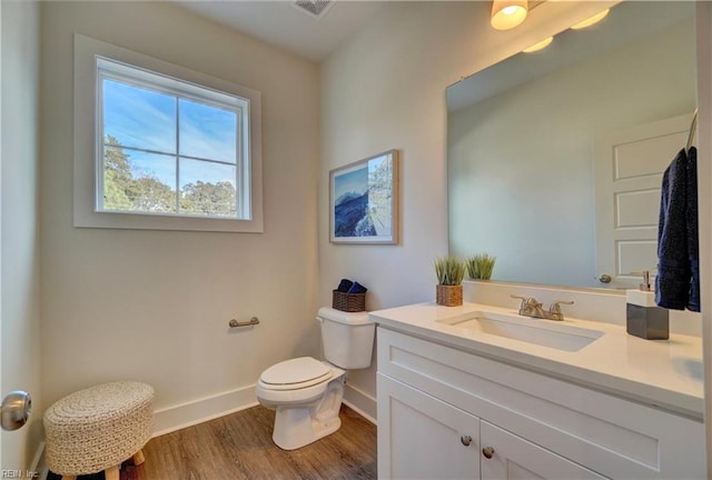 bathroom featuring hardwood / wood-style floors, vanity, and toilet