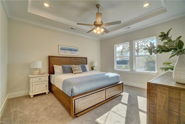 bedroom with a tray ceiling, ceiling fan, crown molding, and light colored carpet