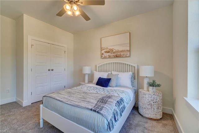 carpeted bedroom with ceiling fan and a closet