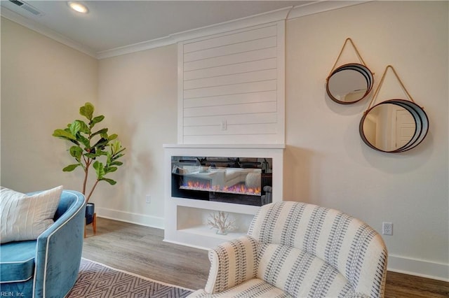 sitting room featuring crown molding and wood-type flooring