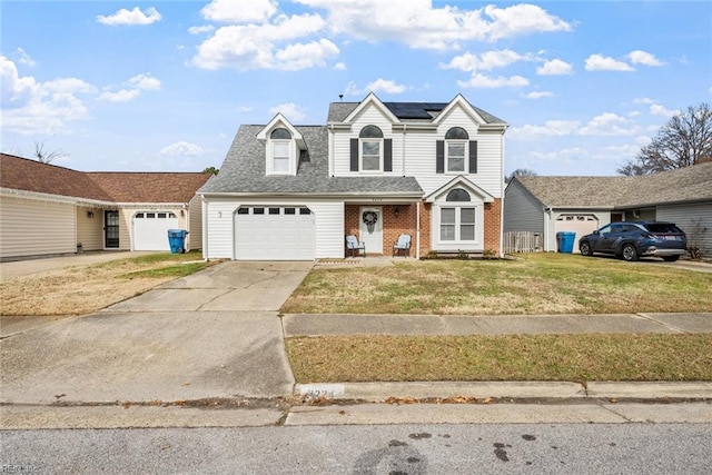 view of front facade with a front lawn, a garage, and solar panels