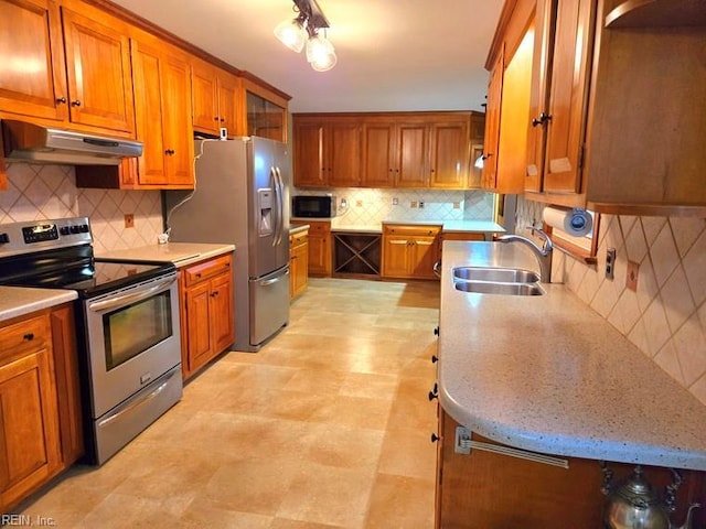 kitchen with backsplash, stainless steel appliances, and sink