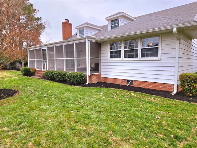 back of property with a lawn and a sunroom