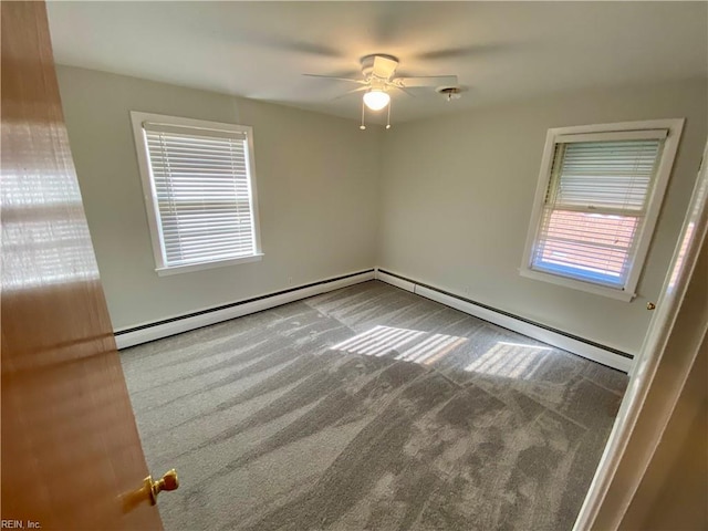 carpeted spare room featuring ceiling fan and a baseboard radiator