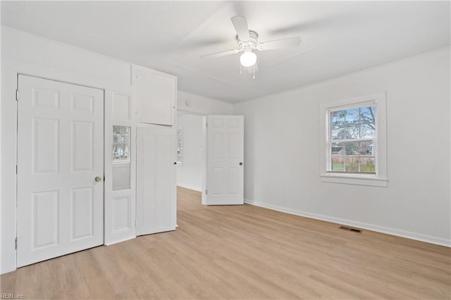 unfurnished bedroom featuring a closet, light hardwood / wood-style flooring, and ceiling fan