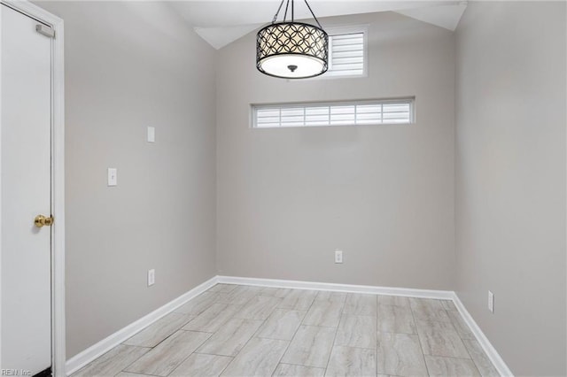 unfurnished room featuring vaulted ceiling and light wood-type flooring