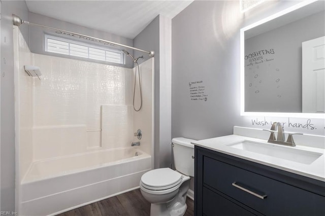 full bathroom featuring hardwood / wood-style floors, vanity, toilet, and bathing tub / shower combination