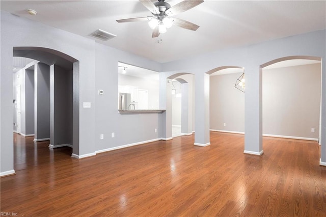 unfurnished living room featuring dark hardwood / wood-style floors and ceiling fan