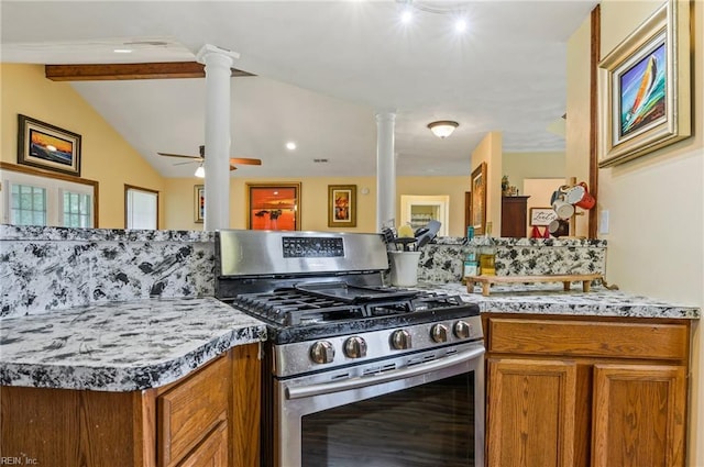 kitchen featuring lofted ceiling with beams, stainless steel gas range, ceiling fan, tasteful backsplash, and decorative columns