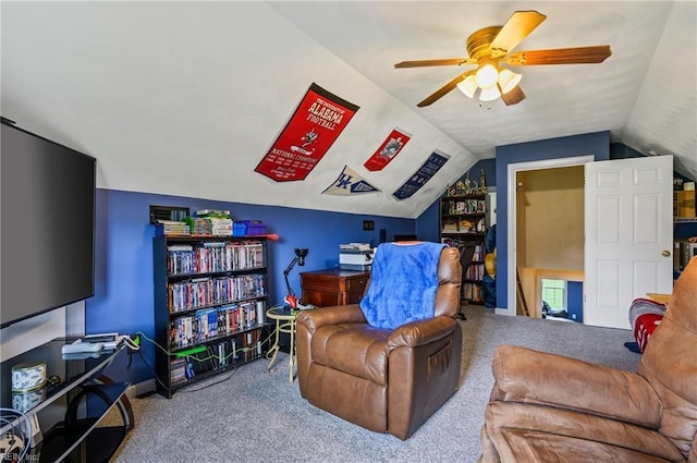 carpeted living room featuring ceiling fan and lofted ceiling