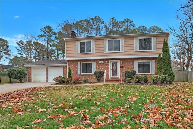 view of front of home with a front yard and a garage