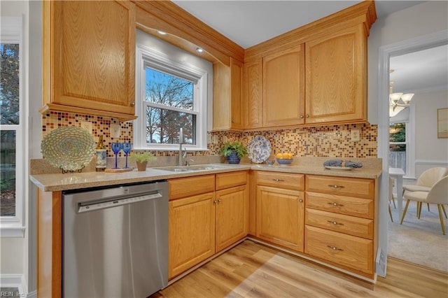 kitchen featuring stainless steel dishwasher, light wood-type flooring, backsplash, and an inviting chandelier