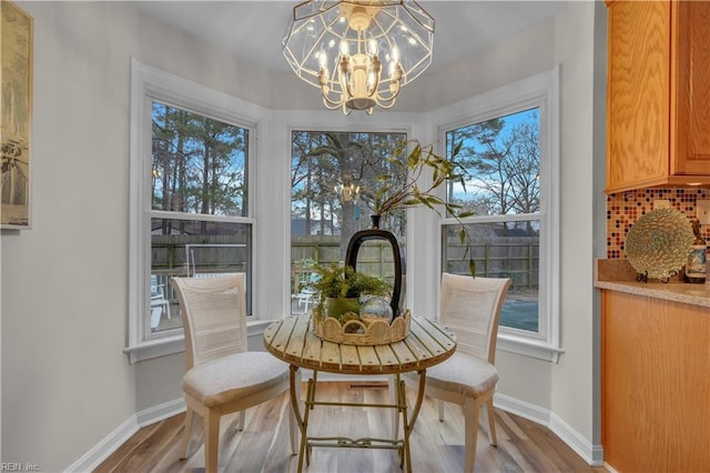 dining room featuring hardwood / wood-style floors and a chandelier