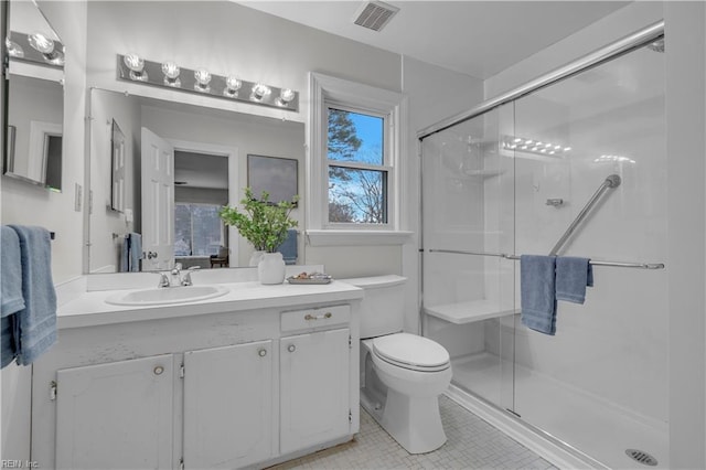 bathroom featuring vanity, toilet, and walk in shower