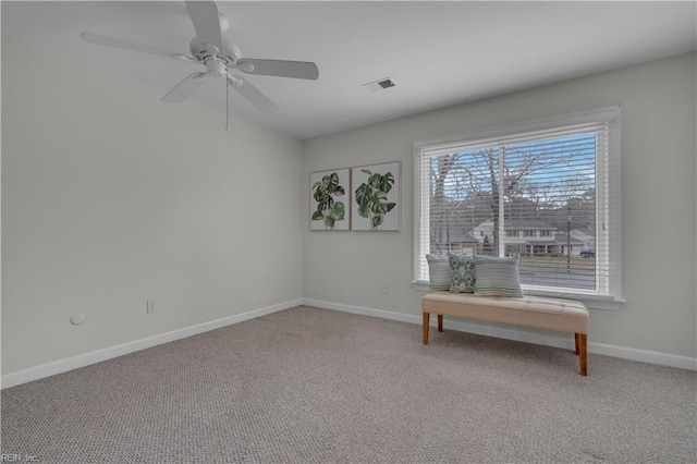 unfurnished room with ceiling fan and carpet floors