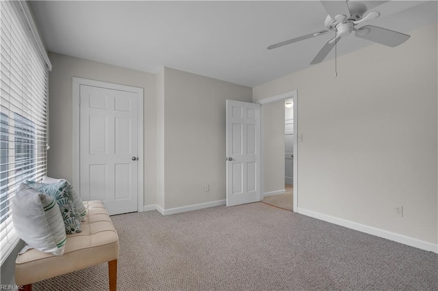 unfurnished room with ceiling fan, a healthy amount of sunlight, and light colored carpet