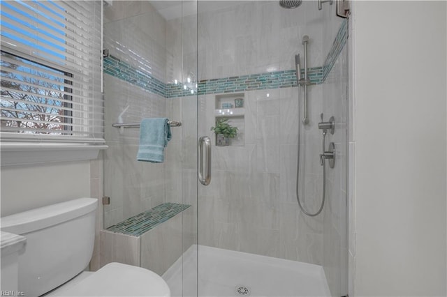 bathroom with toilet and walk in shower