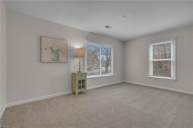 empty room featuring light carpet